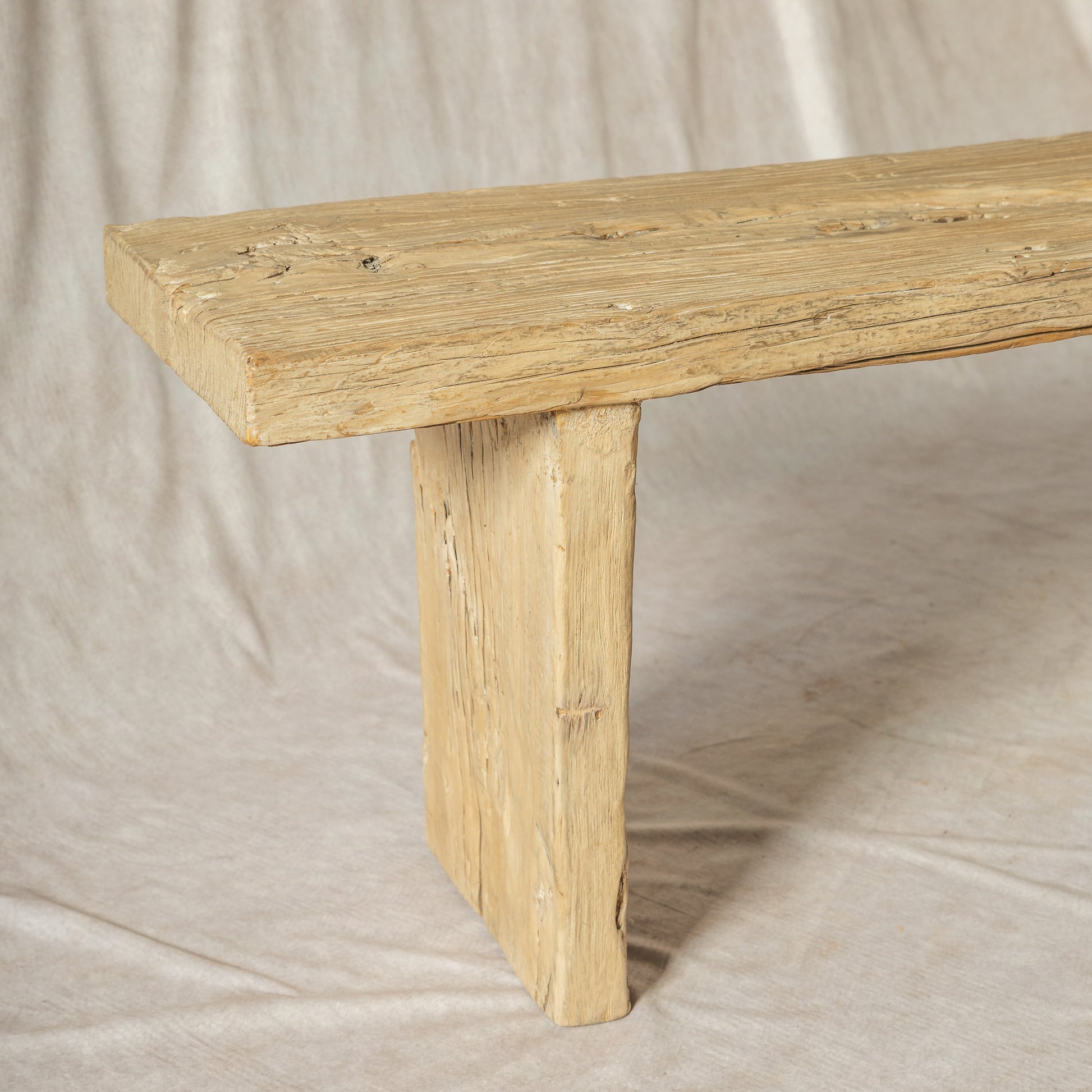 Wooden bench with a rustic finish on a plain background