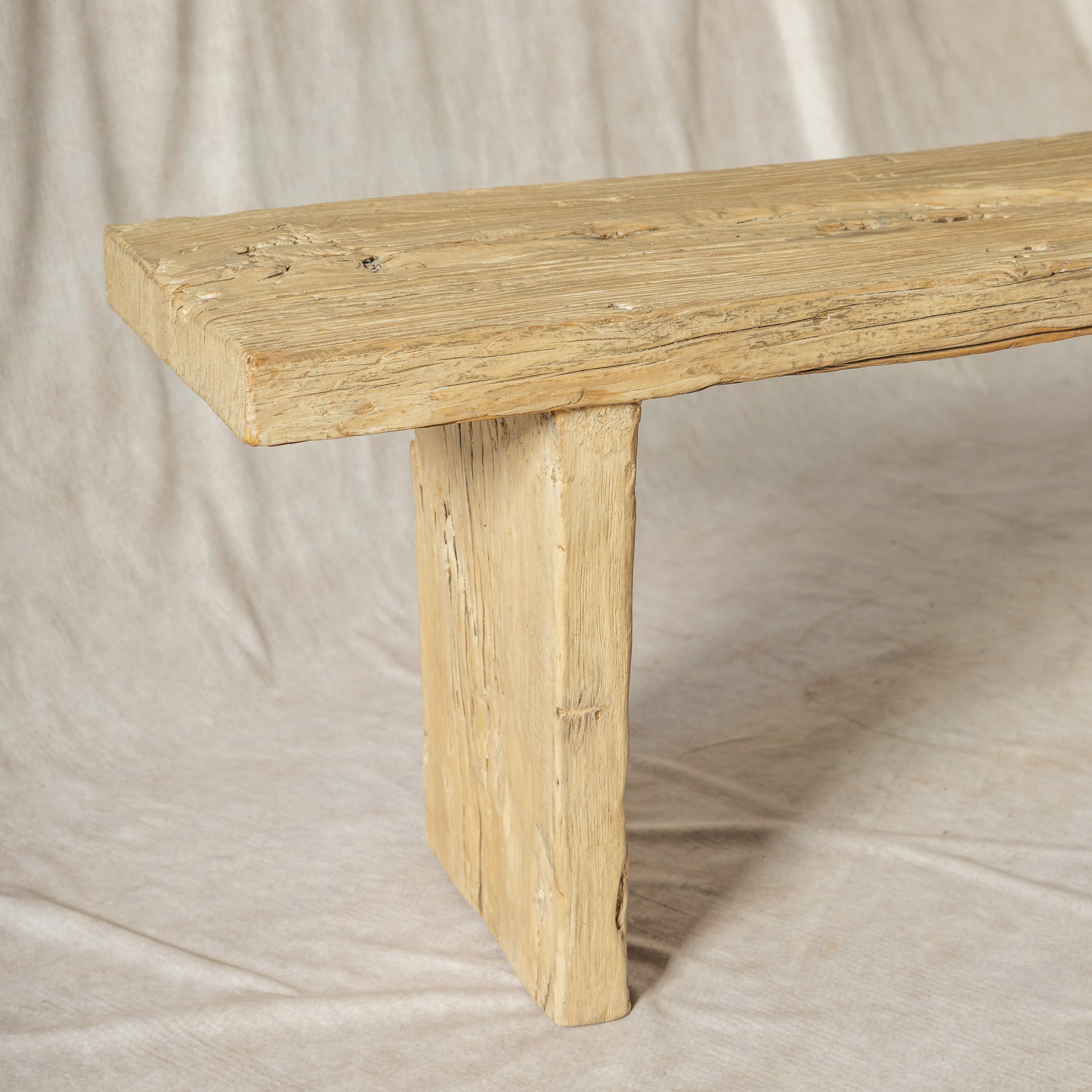 Wooden bench with a rustic finish on a plain background